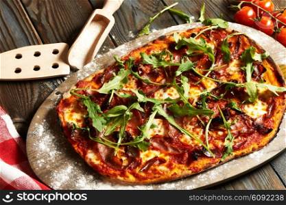 Home made pizza on wooden rustic table