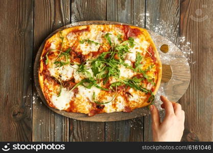 Home made pizza on wooden rustic table