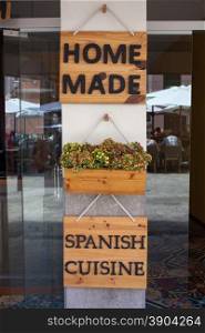 Home made spanish cuisine sign on entrance of restaurant. Home made spanish cuisine sign on restaurant door