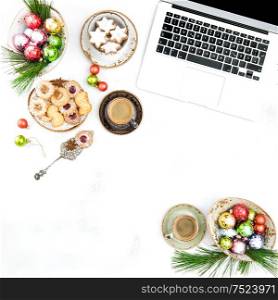 Home office working desk with Christmas decoration. Traditional cookies and coffee. Flat lay