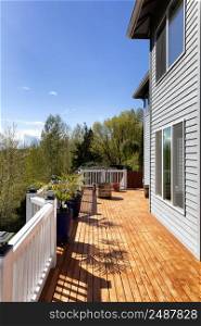 Home outdoor cedar wood deck boards just stained for during early spring season