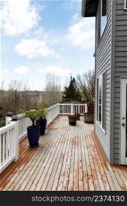 Home outdoor deck during spring time with maintenance to wood boards to prepare to stain in vertical layout