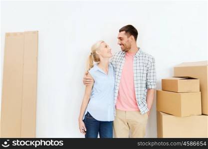 home, people, repair and real estate concept - happy couple with many cardboard boxes moving to new place