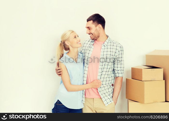 home, people, repair and real estate concept - happy couple with many cardboard boxes moving to new place