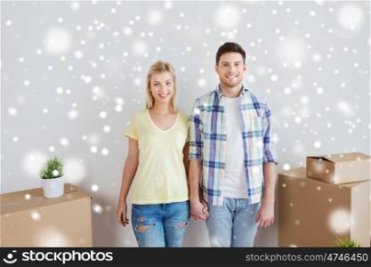 home, people, repair and real estate concept - smiling couple with big cardboard boxes moving to new place over snow