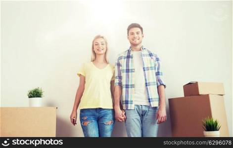 home, people, repair and real estate concept - smiling couple with big cardboard boxes moving to new place. smiling couple with big boxes moving to new home