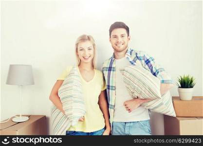 home, people, repair and real estate concept - smiling couple with big cardboard boxes and stuff moving to new place. happy couple with stuff moving to new home
