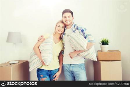 home, people, repair and real estate concept - smiling couple with big cardboard boxes and stuff moving to new place. happy couple with stuff moving to new home