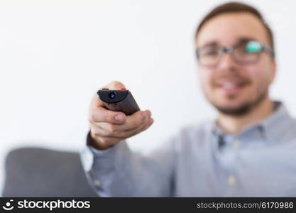 home, people, technology and entertainment concept - smiling man in eyeglasses with tv remote control at home