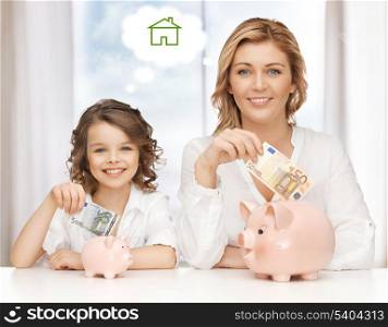 home, real estate and family concept - mother and daughter saving money for new house