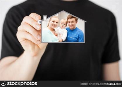 home, real estate, family and technology concept - man and sign of family with child and dream house