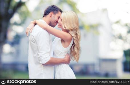 home, real estate, people, love and dating concept - happy couple hugging over summer house background