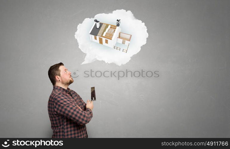 Home renovation and improvement. Man in checked shirt indoors with spatula in hand