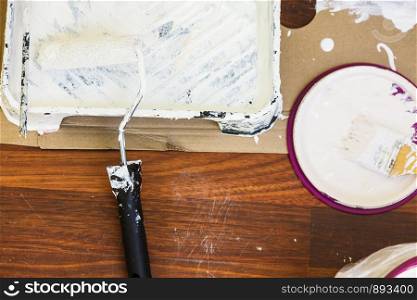 Home renovation, walls color change, diy concept. White paint with essentials equipment.. White paint with essentials equipment