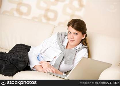 Home shopping - woman with credit card and laptop in lounge