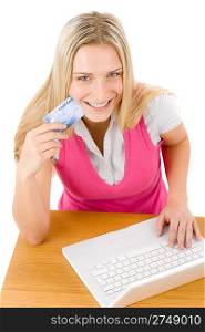 Home shopping - young woman holding credit card on white background