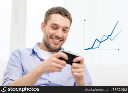 home, technology and internet concept - smiling man with smartphone sitting on couch at home