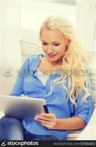 home, technology and internet concept - smiling woman lying on the couch with tablet pc computer at home