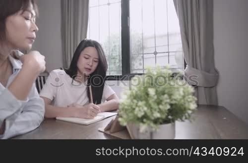 Home tuition schooling concept, asian student study e-learning from tablet, private tuition lesson at home, personal consultant program, question and answer working at home, homework project