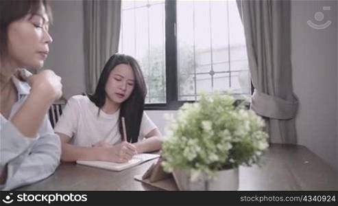 Home tuition schooling concept, asian student study e-learning from tablet, private tuition lesson at home, personal consultant program, question and answer working at home, homework project