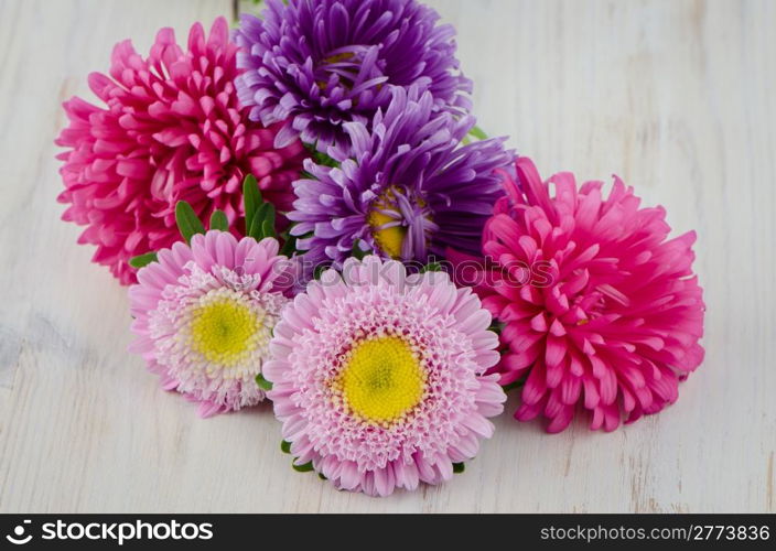 Homegrown fall garden flowers on a white wooden table.