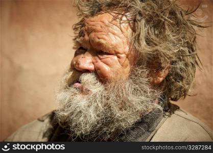 homeless man talking about hard life, special toned photo f/x, focus point on eye