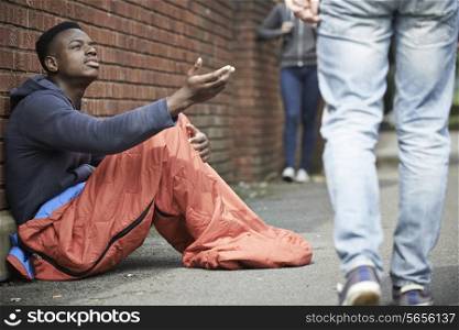 Homeless Teenage Boy Begging For Money On The Street