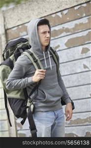 Homeless Teenage Boy On Street With Rucksack