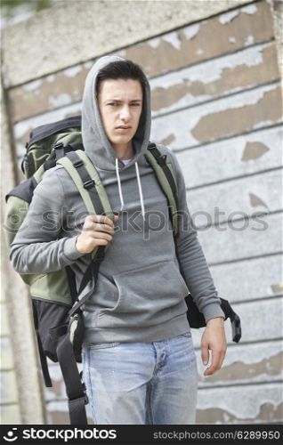 Homeless Teenage Boy On Street With Rucksack