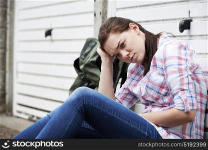 Homeless Teenage Girl On Streets With Rucksack