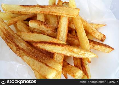 Homemade &acute;french fried&acute; potato chips in waxed paper.