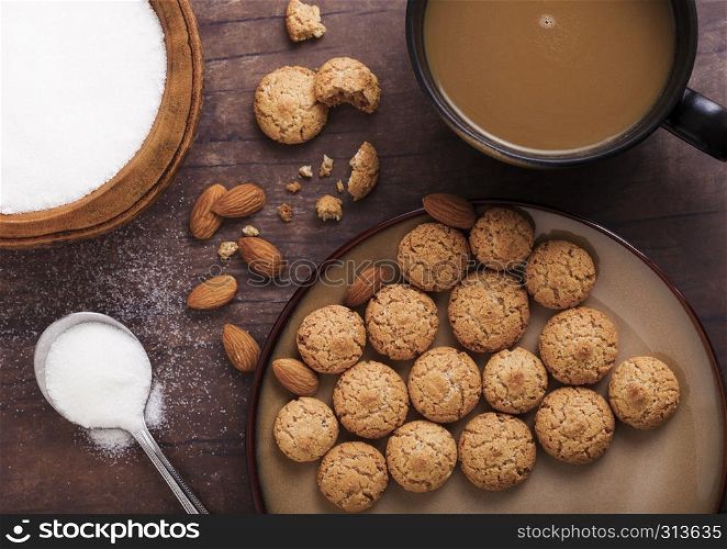Homemade almond biscuit cookies with cappuccino and bowl of sugar