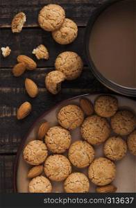 Homemade almond biscuit cookies with cappuccino on wooden background