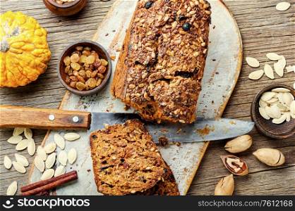 Homemade autumn bread, pumpkin bread on wooden table.. Pumpkin bread loaf
