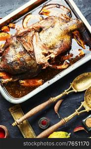Homemade baked goose stuffed with pumpkin and mushrooms.. Appetizing roasted goose
