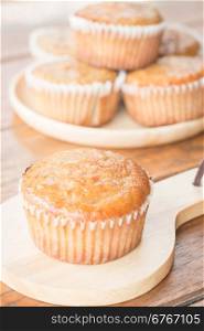 Homemade banana muffins on wooden plate, stock photo