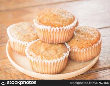 Homemade banana muffins on wooden plate, stock photo