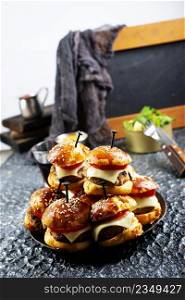 homemade beef burgers with cheese on serving board
