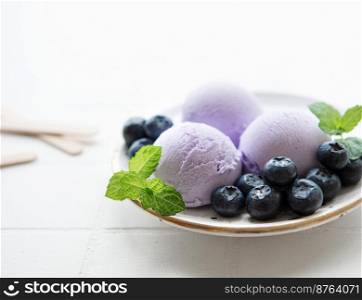 Homemade blueberry  ice cream with fresh blueberries. Sweet berry summer dessert. Concrete background