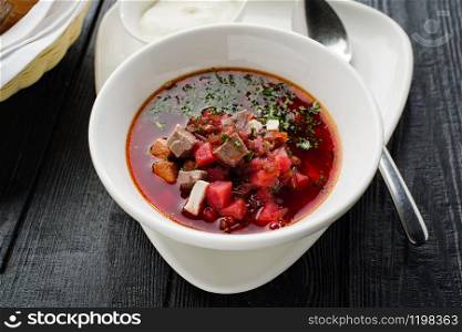 Homemade borsch with meat and sour cream