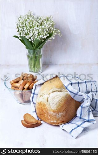 Homemade bread in a towel on a wooden board