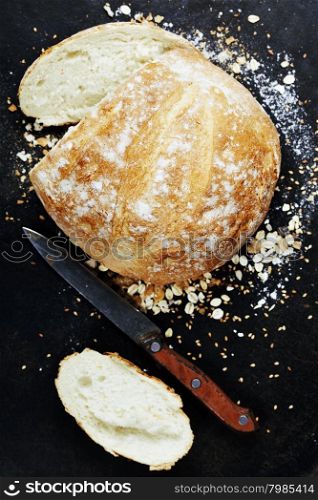 Homemade bread loaf on rustic dark background