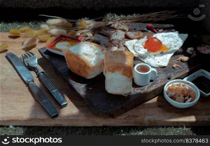 Homemade breakfast with Fried egg, Fried bacon and Toasts served with Honey on Wooden cutting board. Healthy food concept, Selective Focus.