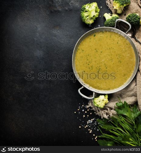 Homemade broccoli soup puree on a dark rustic background