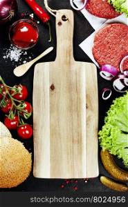 Homemade burger ingredients and empty cutting board - food background concept