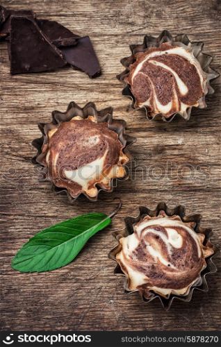 homemade cakes. baked chocolate dessert in iron forms on wooden surface.Photo tinted