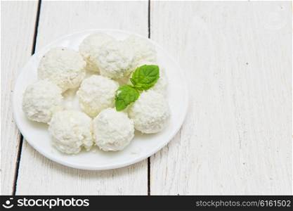 Homemade candies with coconut. Homemade coconut candies with filling of cream and nut