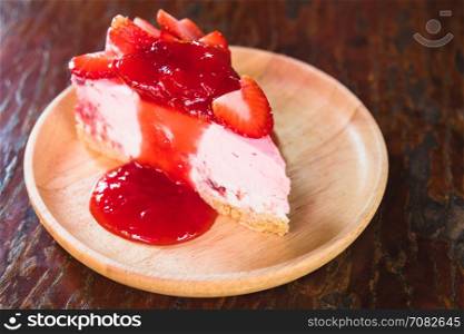 homemade cheesecake with strawberries on wooden dish