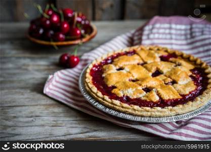 Homemade cherry pie on rustic background
