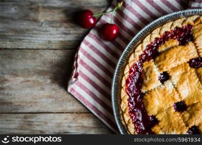 Homemade cherry pie on rustic background